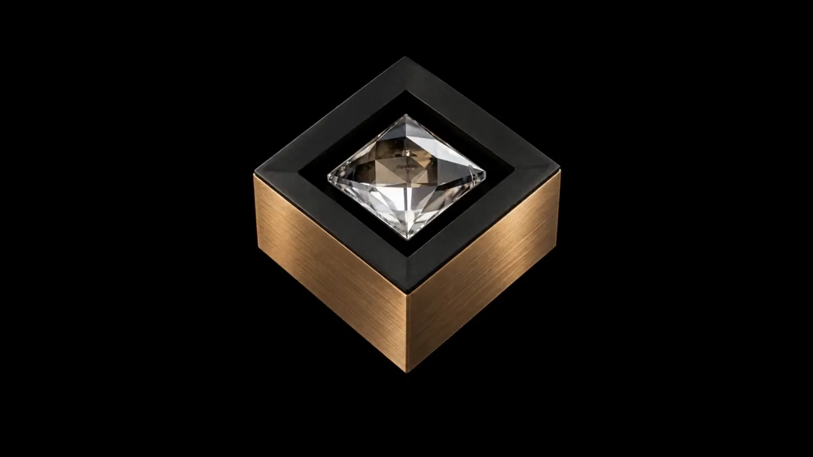 MOIRA IRIS crystal spotlight with brushed bronze sides, a black front and a square faceted crystal against a black background.