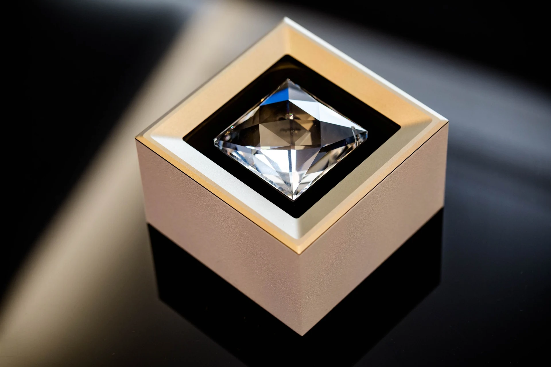 MOIRA IRIS crystal spotlight with a bronze-toned housing, black inner frame and square faceted crystal.